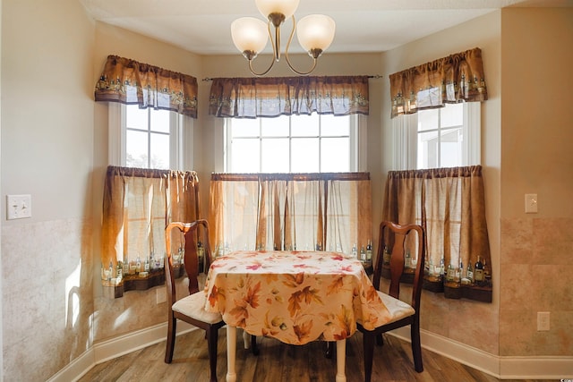 dining area featuring hardwood / wood-style floors, a notable chandelier, and a wealth of natural light