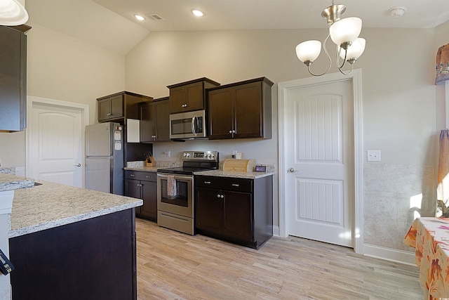 kitchen featuring dark brown cabinetry, an inviting chandelier, pendant lighting, light hardwood / wood-style floors, and appliances with stainless steel finishes