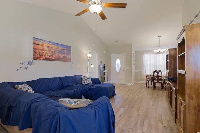 living room with ceiling fan with notable chandelier, light hardwood / wood-style floors, and high vaulted ceiling