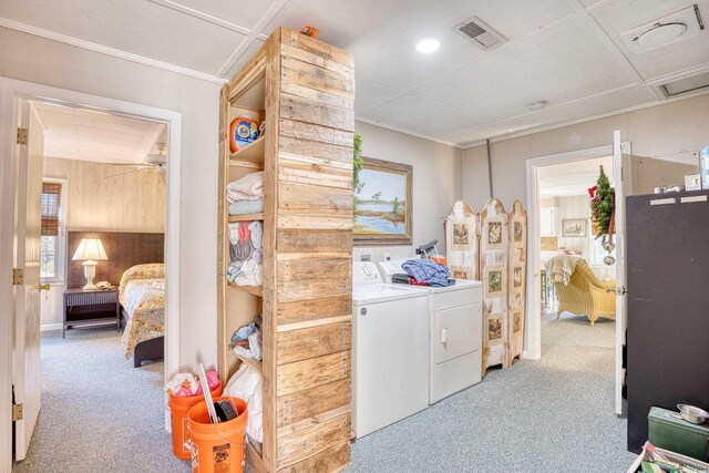 laundry room featuring light colored carpet and washer and dryer