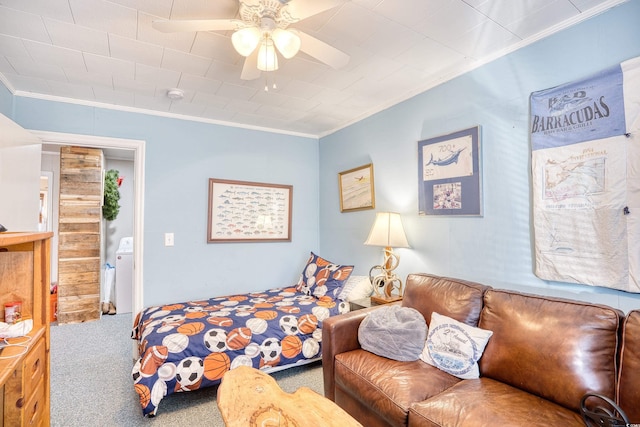 carpeted bedroom featuring ceiling fan, washer / dryer, and crown molding