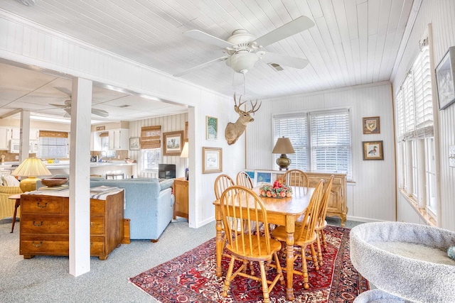 dining space with crown molding and wooden ceiling