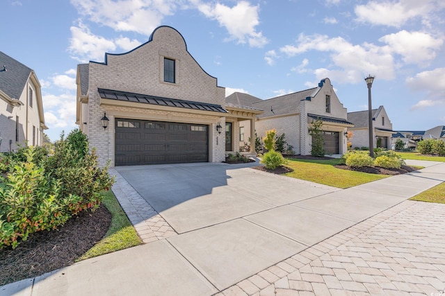 french country inspired facade featuring a front lawn and a garage