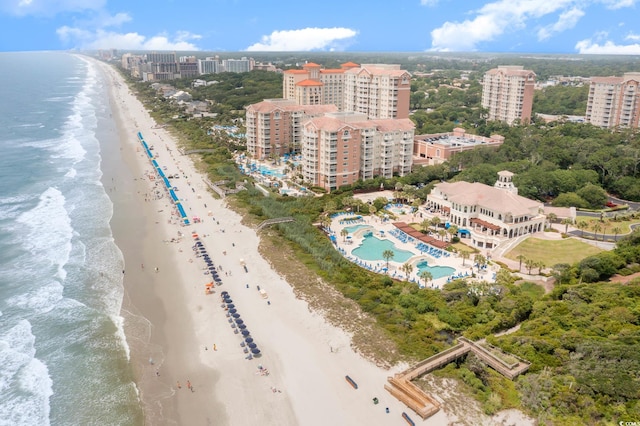 birds eye view of property featuring a water view and a beach view