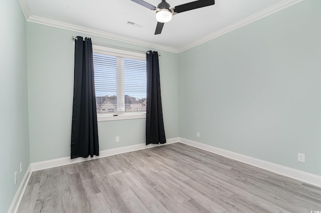 spare room featuring ceiling fan, ornamental molding, and light hardwood / wood-style flooring