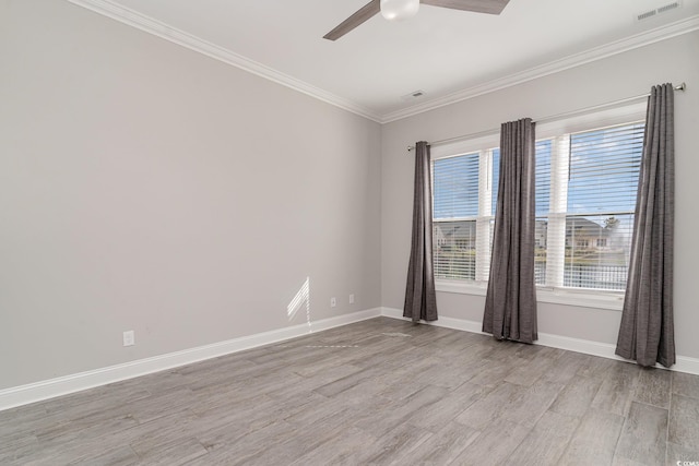 spare room featuring ornamental molding, light hardwood / wood-style floors, and ceiling fan