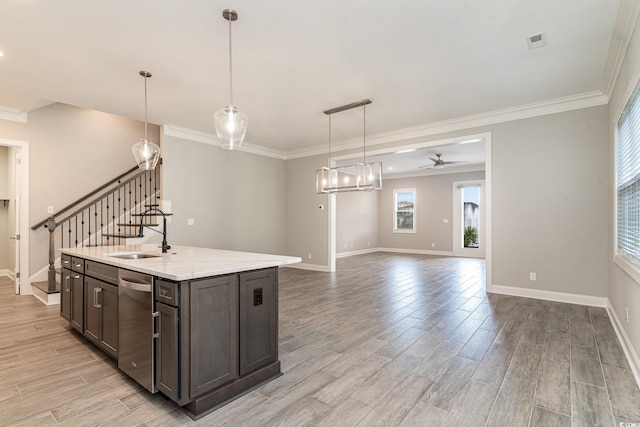 kitchen featuring decorative light fixtures, light wood-type flooring, and a healthy amount of sunlight