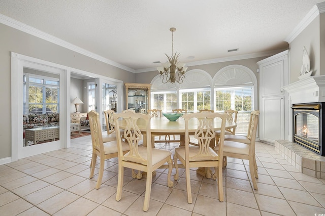 tiled dining area with crown molding, a healthy amount of sunlight, and a tile fireplace