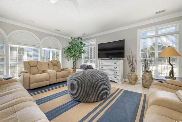 living room featuring a wealth of natural light, crown molding, a textured ceiling, and ceiling fan