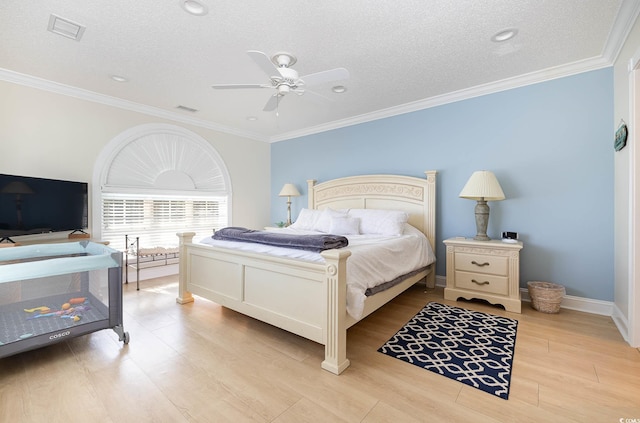 bedroom featuring ornamental molding, light wood-type flooring, and ceiling fan