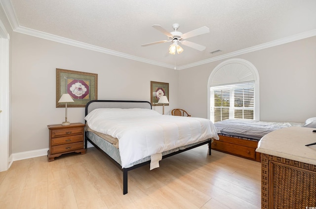 bedroom with ceiling fan, ornamental molding, a textured ceiling, and light wood-type flooring