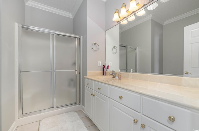 bathroom featuring a shower with door, crown molding, tile patterned flooring, and vanity