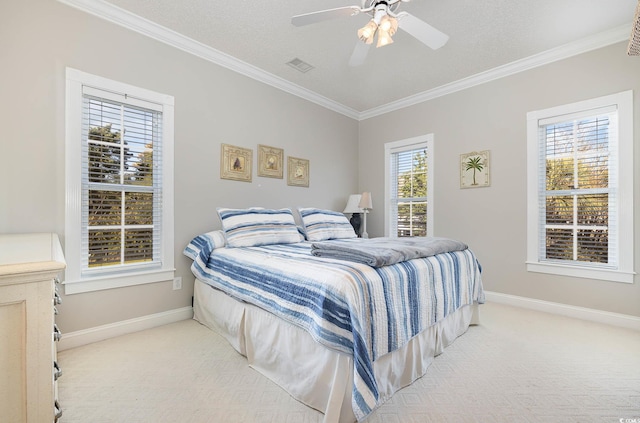 bedroom with a textured ceiling, ornamental molding, light colored carpet, and ceiling fan