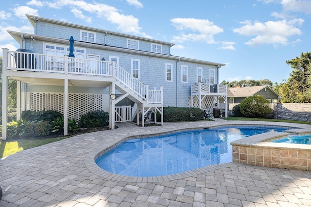 view of pool featuring a wooden deck, a patio area, and cooling unit