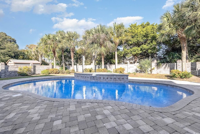 view of swimming pool featuring a patio area and a jacuzzi