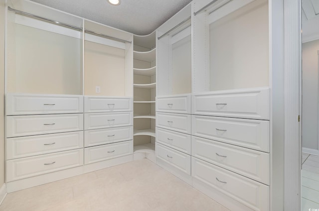 walk in closet featuring light tile patterned flooring