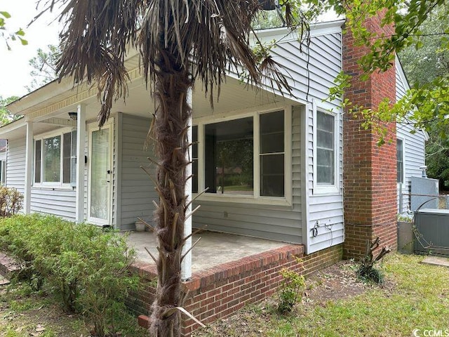 view of side of home with a patio