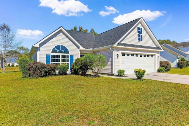 view of front of home with a garage and a front lawn