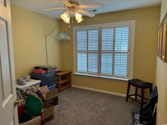 rec room featuring a textured ceiling, carpet, and ceiling fan