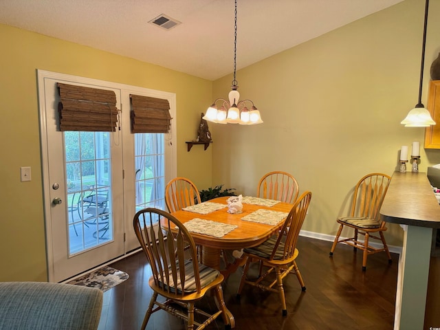 dining room featuring a notable chandelier and dark hardwood / wood-style flooring