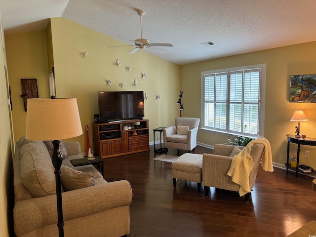 living room featuring a textured ceiling, vaulted ceiling, dark hardwood / wood-style floors, and ceiling fan