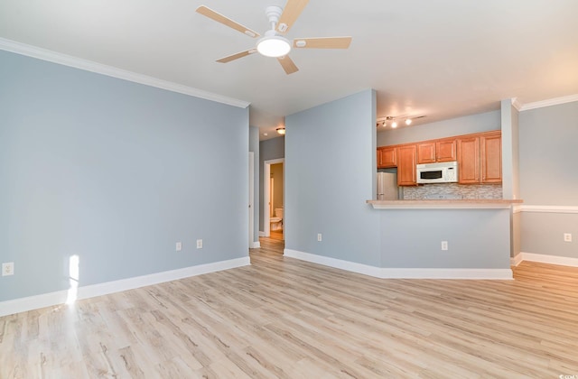 unfurnished living room with baseboards, a ceiling fan, crown molding, and light wood finished floors