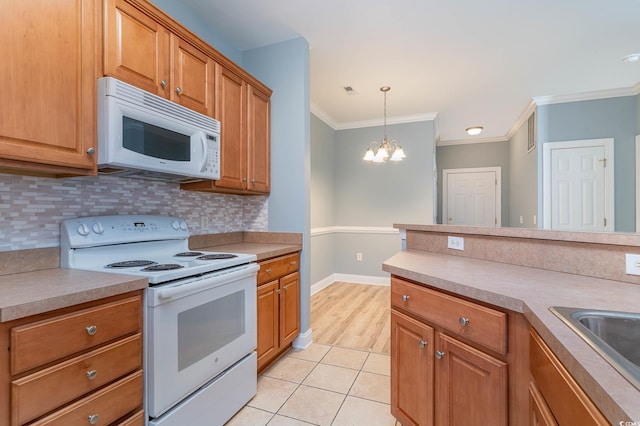 kitchen featuring light countertops, white appliances, tasteful backsplash, and crown molding