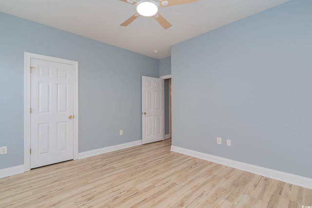 unfurnished bedroom with ceiling fan and light wood-type flooring