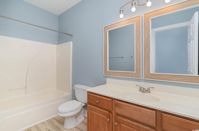 full bathroom featuring vanity, toilet, hardwood / wood-style flooring, and tub / shower combination