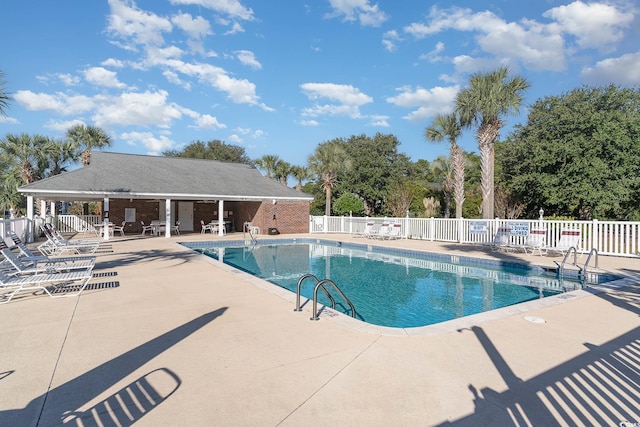 pool with fence and a patio