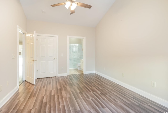 empty room featuring light wood-type flooring, ceiling fan, and lofted ceiling