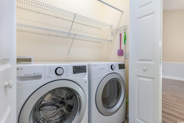 laundry room featuring hardwood / wood-style floors and separate washer and dryer