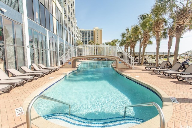 view of swimming pool with a patio area