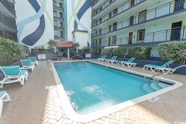 view of swimming pool featuring a patio area