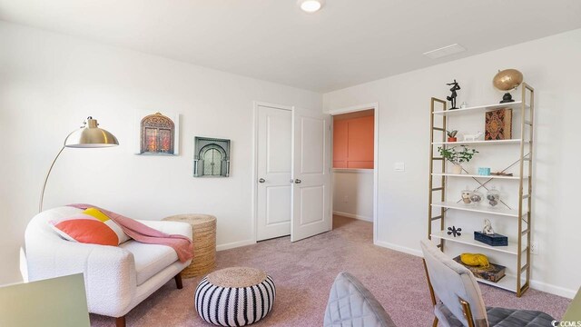 living area with light colored carpet