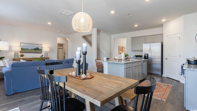 interior space featuring an inviting chandelier and dark wood-type flooring