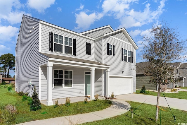 view of front of house featuring a front yard and a garage