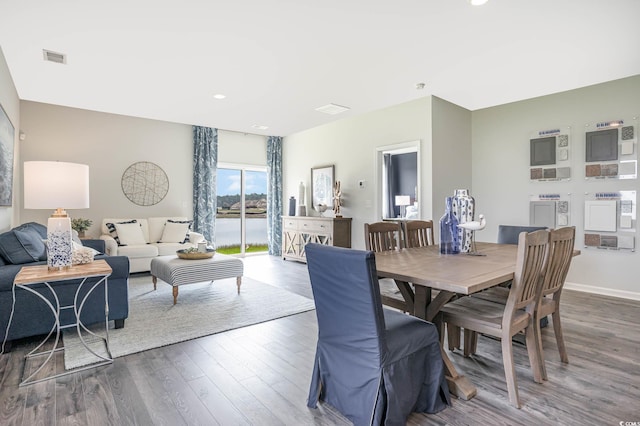 dining space with dark hardwood / wood-style flooring