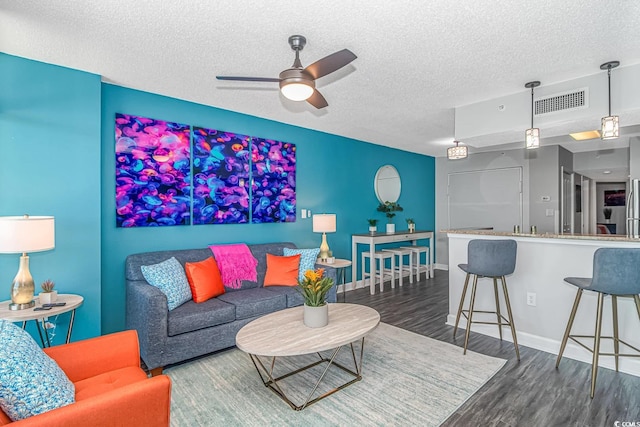 5300 N Ocean Blvd Unit 1405, Myrtle Beach, SC 29577 - living area featuring a textured ceiling, visible vents, baseboards, wood finished floors, and a ceiling fan