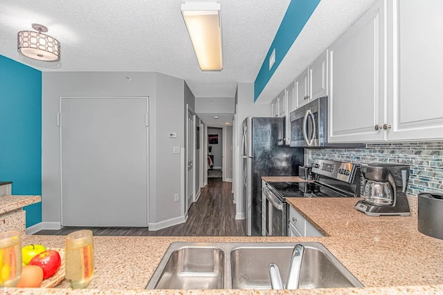 5300 N Ocean Blvd Unit 1405, Myrtle Beach, SC 29577 - kitchen with appliances with stainless steel finishes, light countertops, backsplash, a sink, and dark wood-style floors
