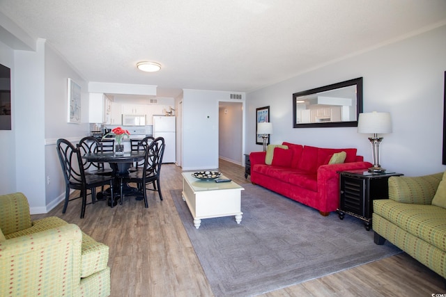 living room featuring a textured ceiling and hardwood / wood-style flooring