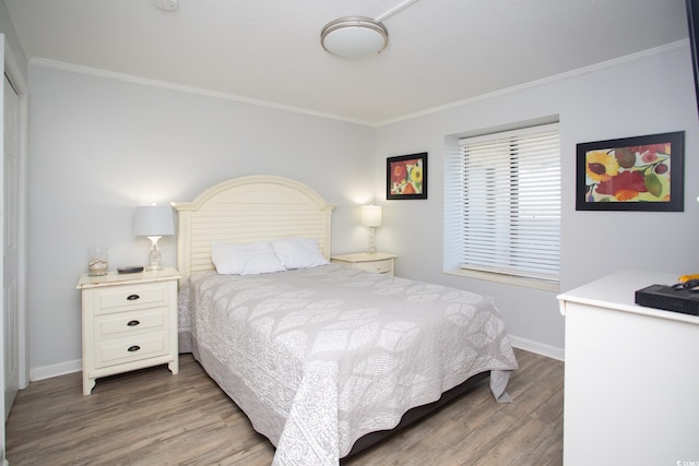 bedroom featuring ornamental molding and hardwood / wood-style floors