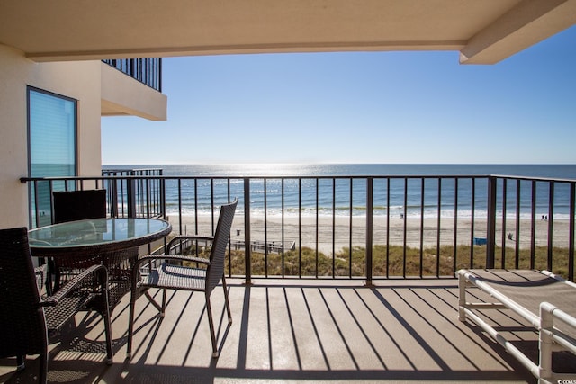 balcony with a water view and a beach view