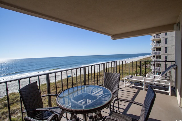 balcony with a water view and a beach view