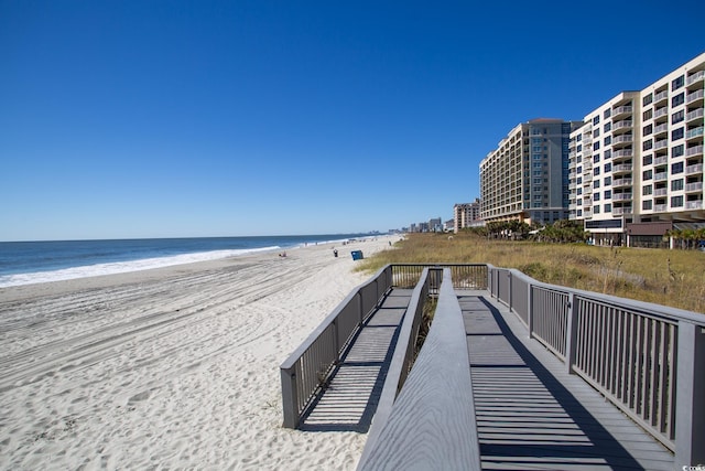 surrounding community with a view of the beach and a water view