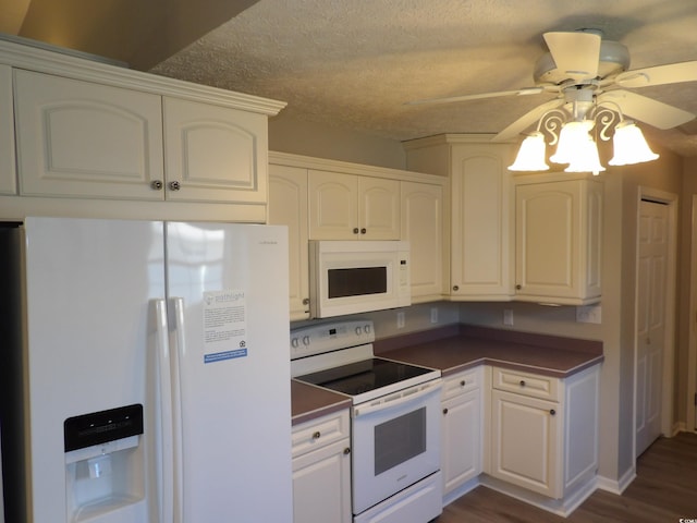 kitchen with dark hardwood / wood-style flooring, white cabinetry, ceiling fan, and white appliances