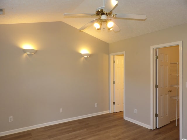 unfurnished bedroom with dark wood-type flooring, vaulted ceiling, and ceiling fan