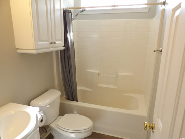 full bathroom featuring sink, shower / bath combination with curtain, and toilet