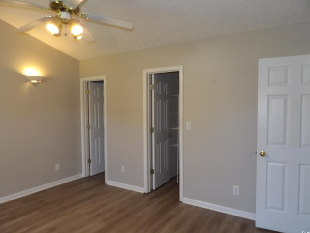 unfurnished bedroom featuring ceiling fan and dark hardwood / wood-style flooring