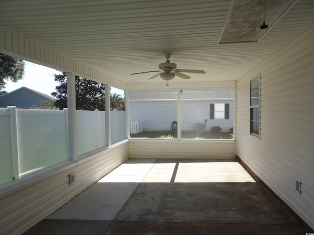 unfurnished sunroom with ceiling fan